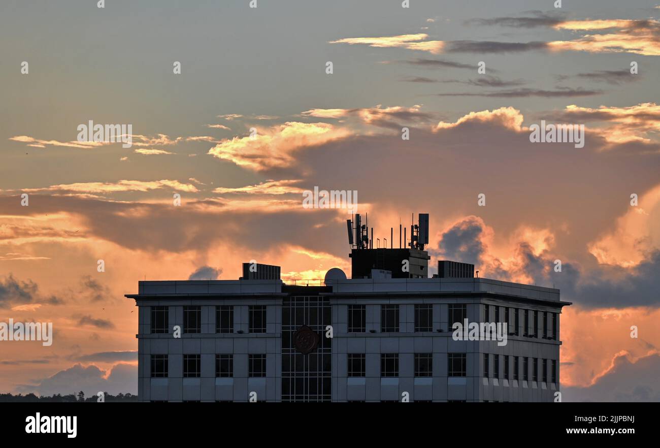Silhouette construction building against orange hi-res stock ...