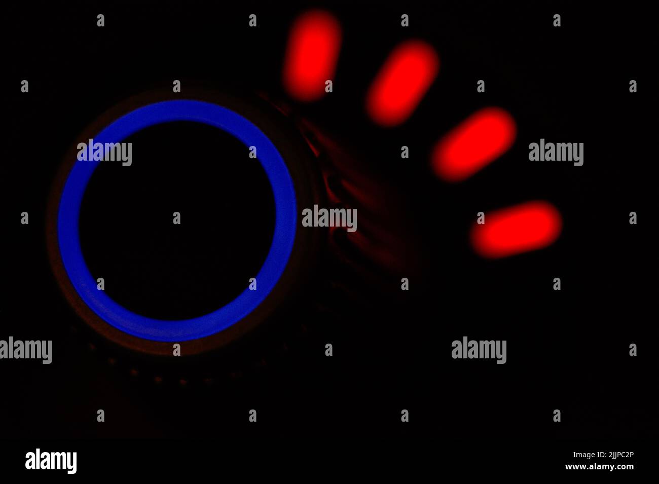 A glowing button on a blurred background Stock Photo