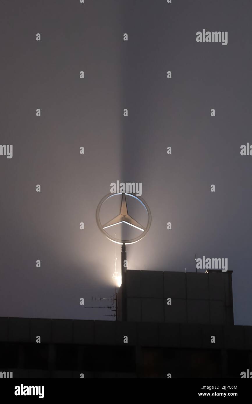 A backlit Mercedes Benz emblem at night Stock Photo Alamy