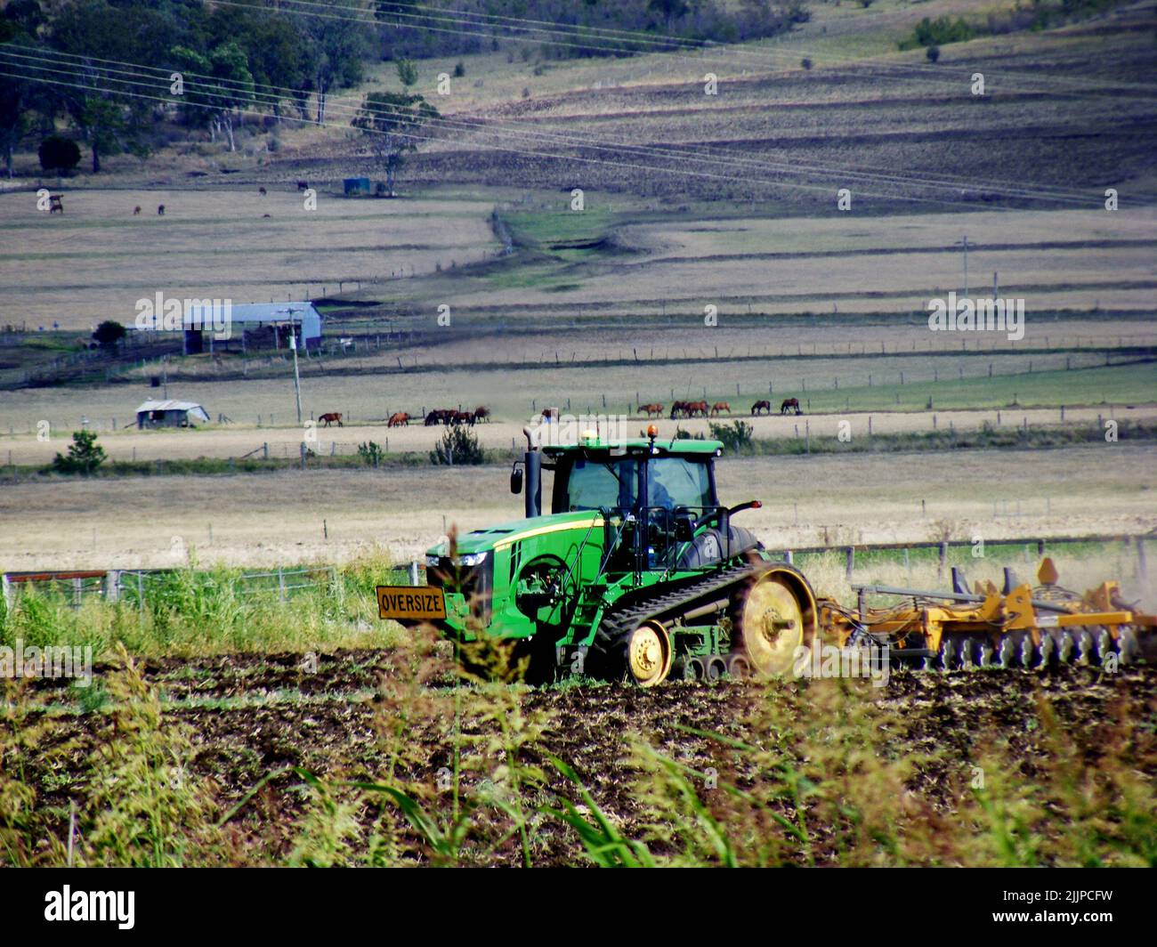 A tractor working on a farm near Tamworth Northern NSW in Australia Stock Photo