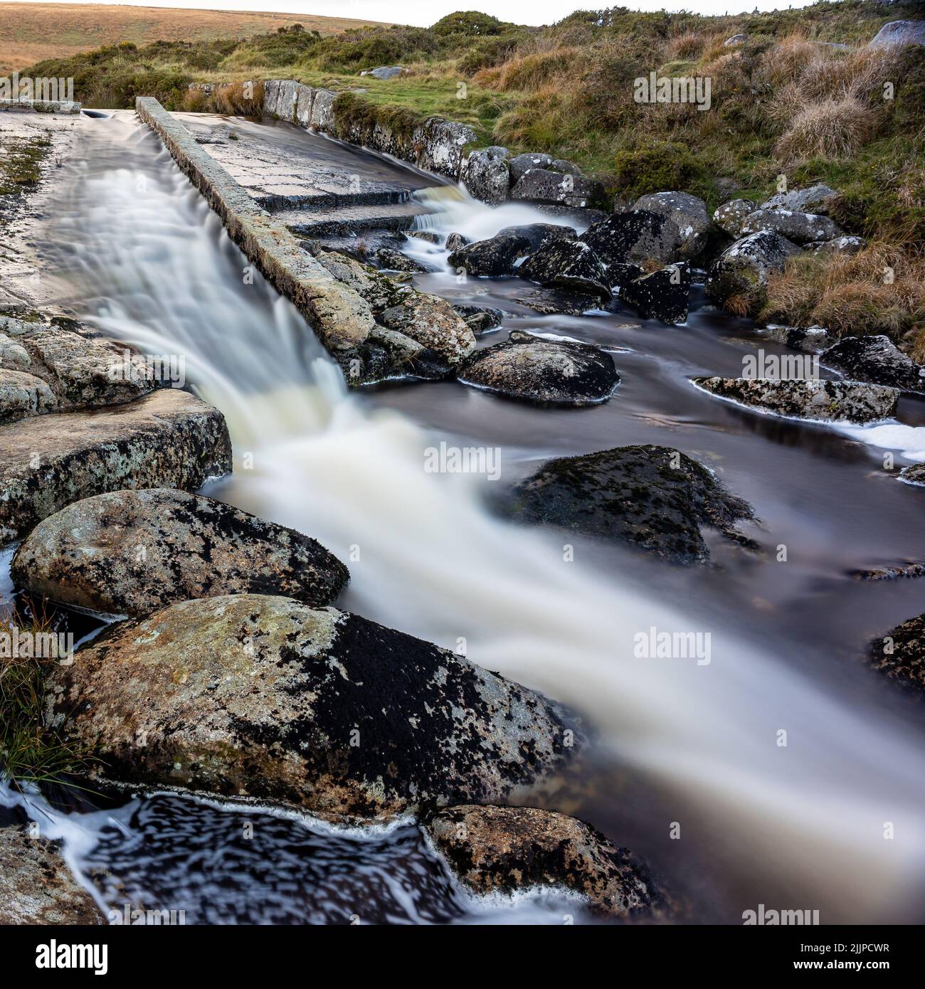A mesmerizing scene of flowing majestic water with rocks into the Devonport Leat with trees Stock Photo