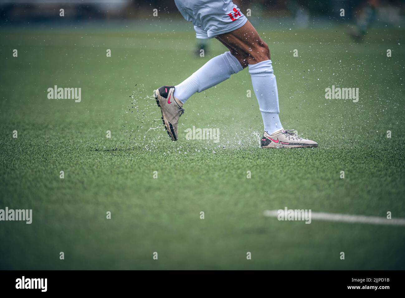 Soccer ball on the rainy playing field Stock Photo Alamy