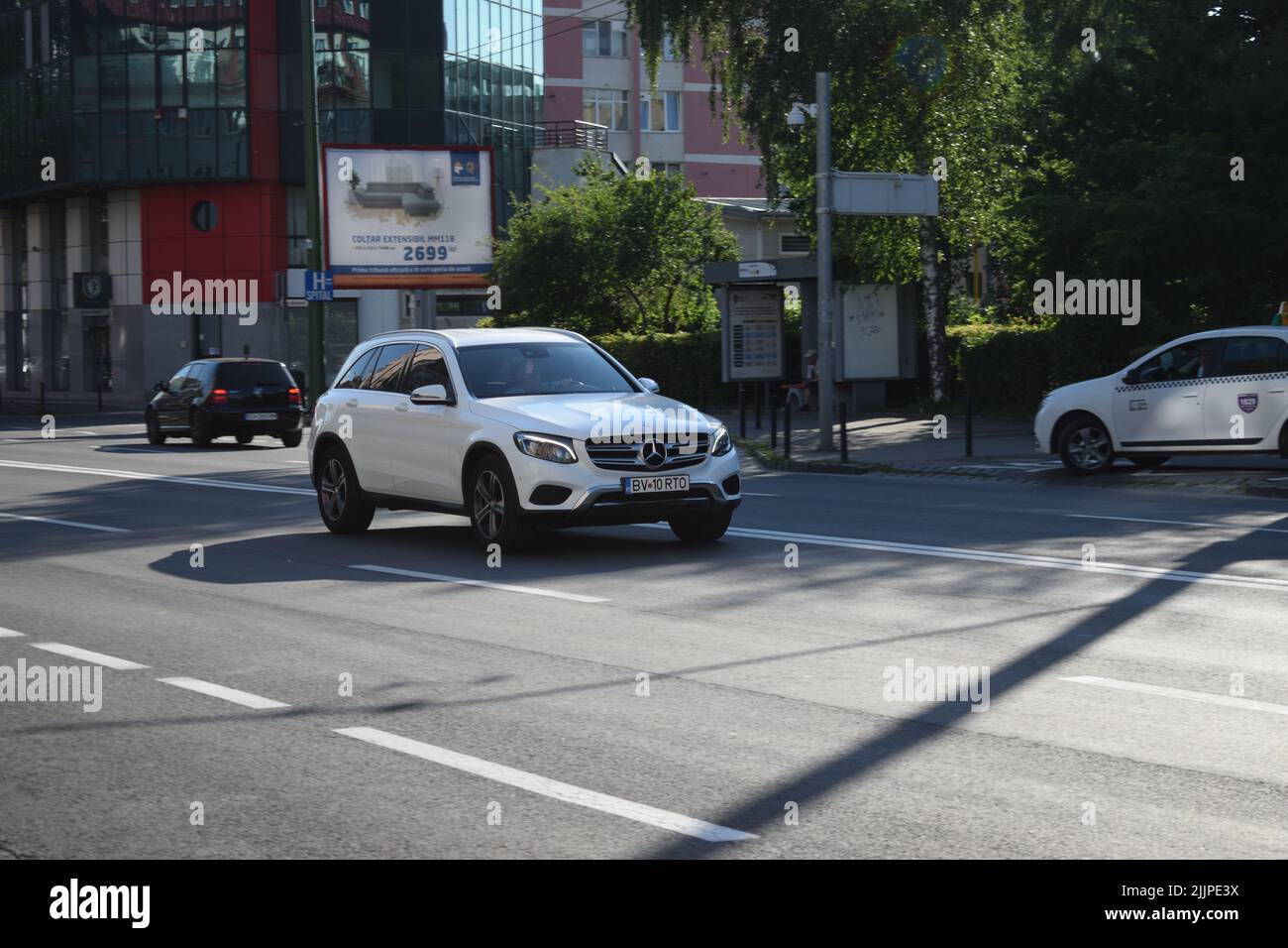 A white Mercedes-Benz on the street in Brasov, Romania, in summer Stock Photo