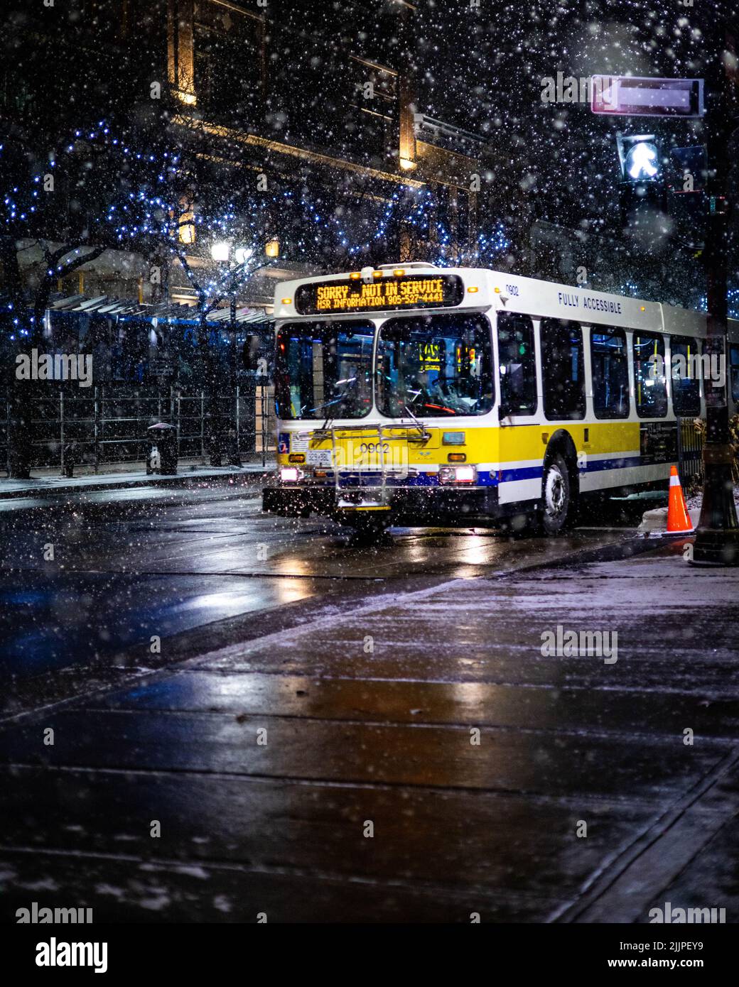 A vertical shot of a bus in Hamilton Ontario City at night Stock Photo