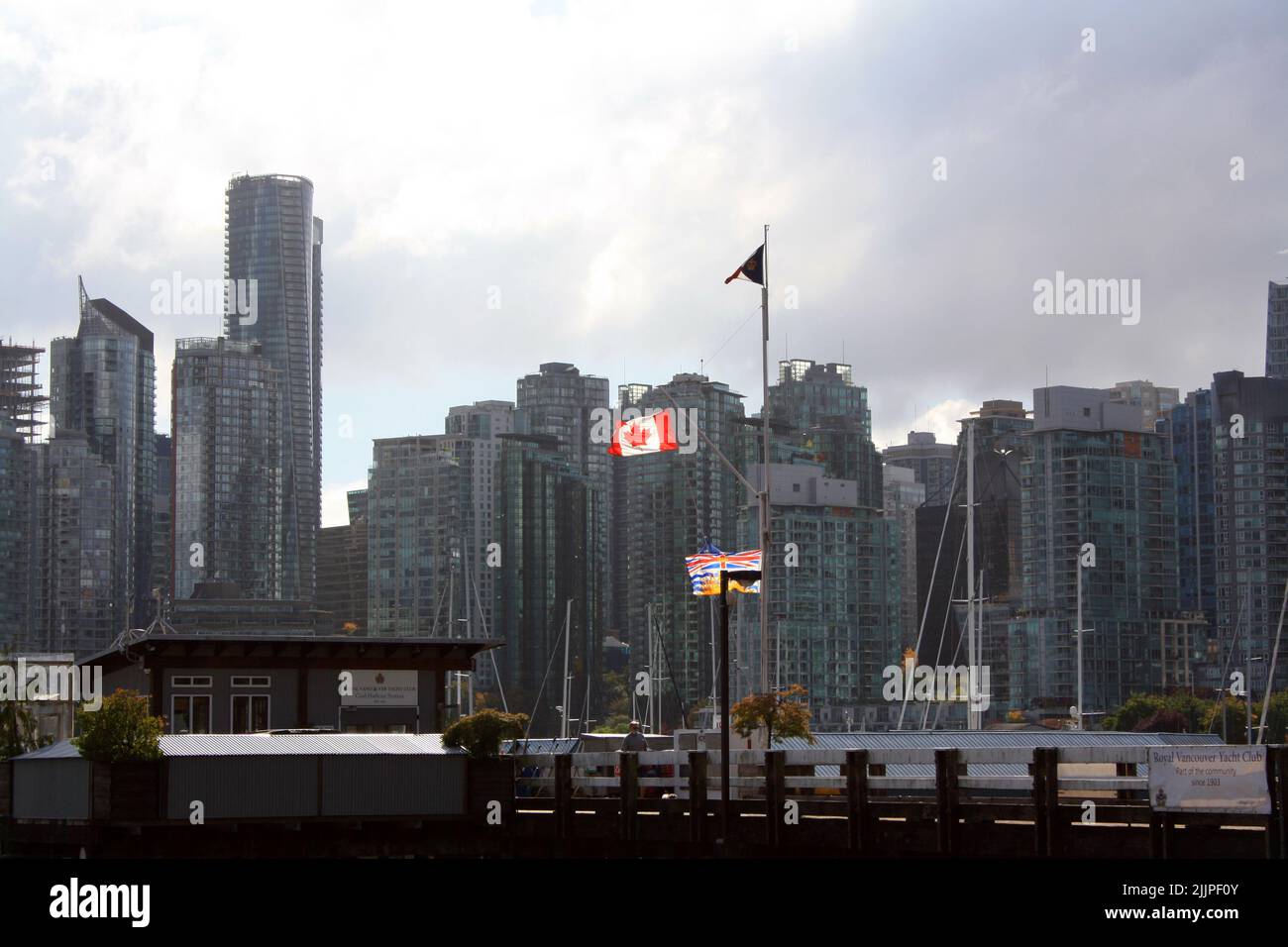 The Canadian and other flags on a flagpole in Vancouver, Canada Stock