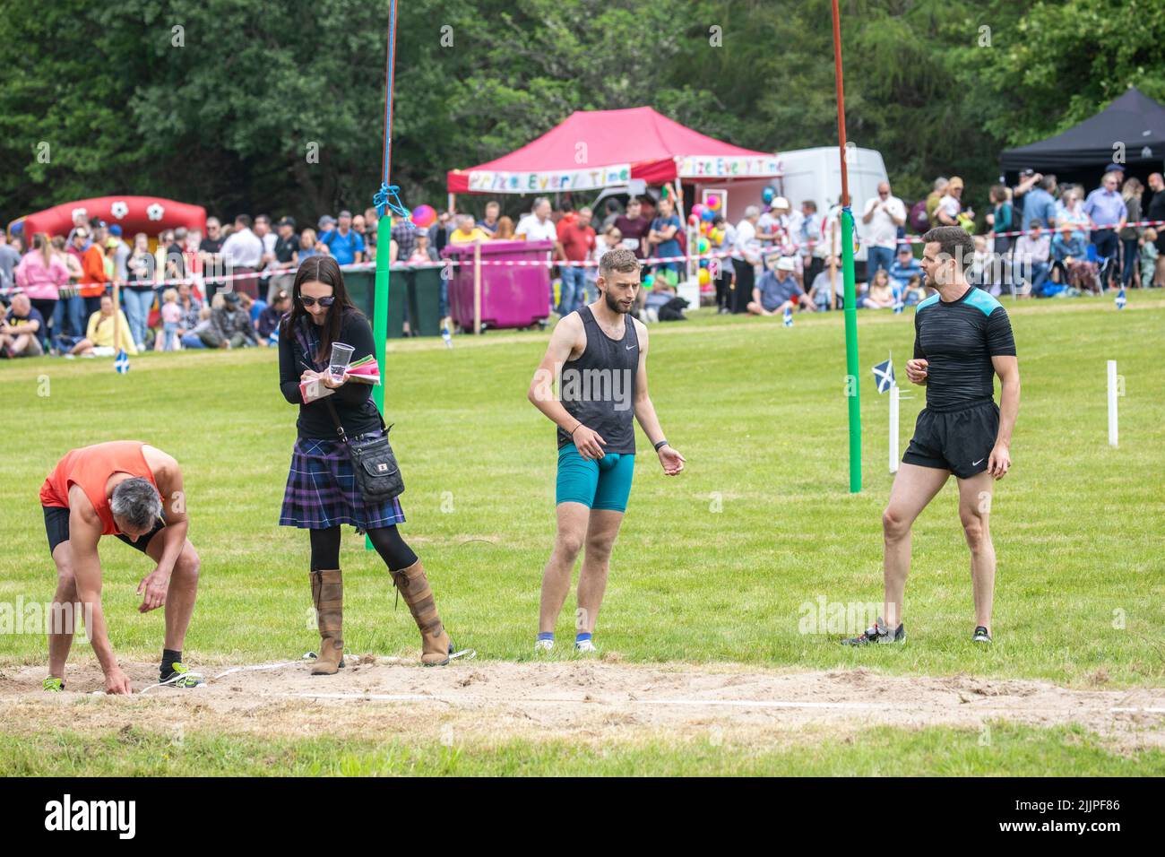 Tomintoul Highland games 2022, competitors and judges in the Highland games long jump contest,Scotland,Uk,summer 2022 Stock Photo