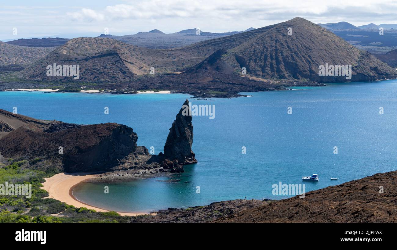 An aerial view of Bartolome island and the Pinnacle rock with Santiago Island in the background - Galapagos Islands Stock Photo