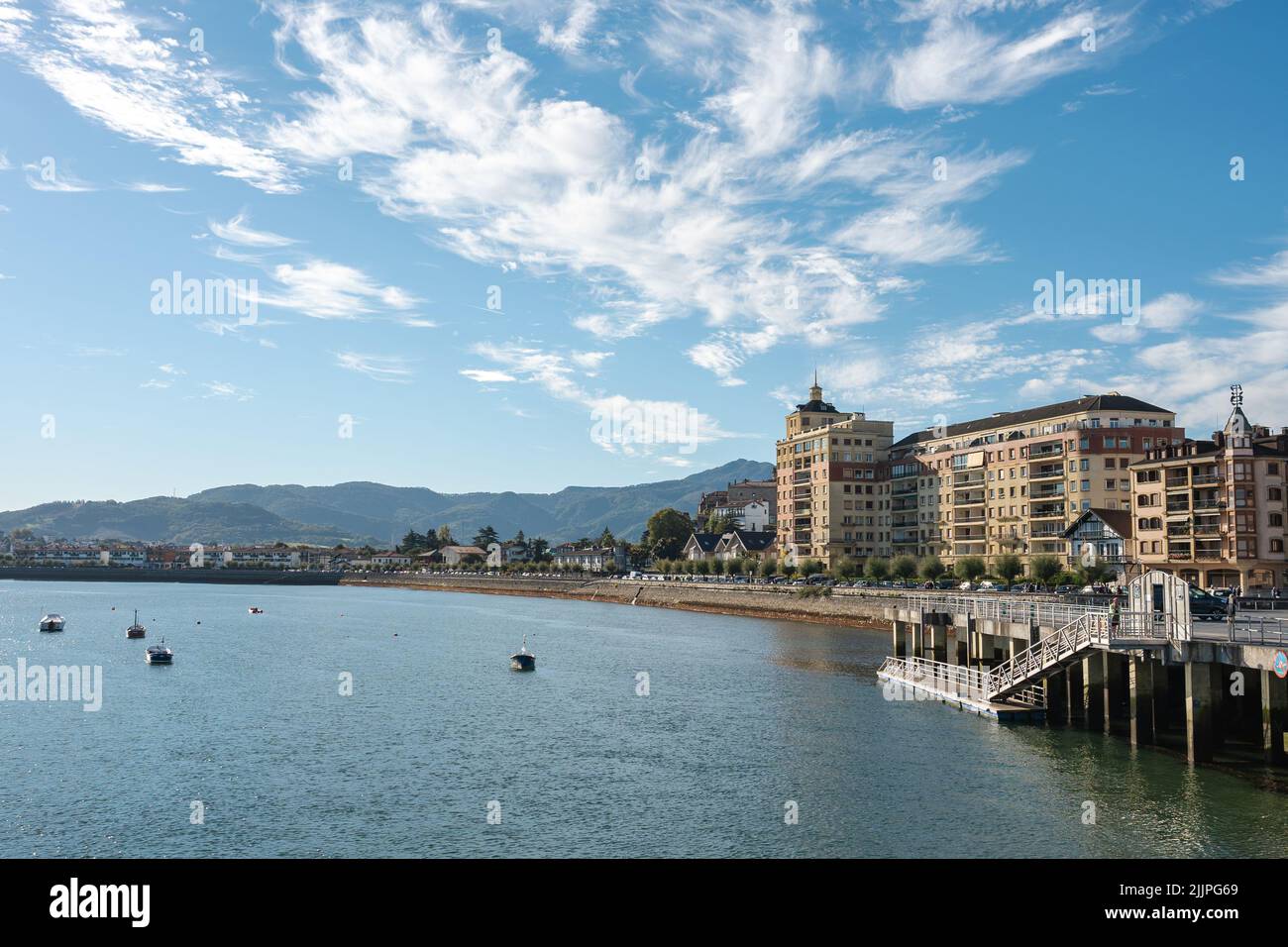 The coastal buildings and boats in the sea in Hondarribia, Spain Stock Photo