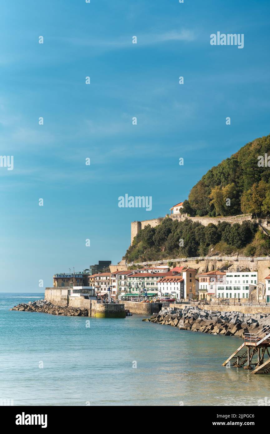 A scenic view of the coastal city of San Sebastian in Spain under blue skies Stock Photo