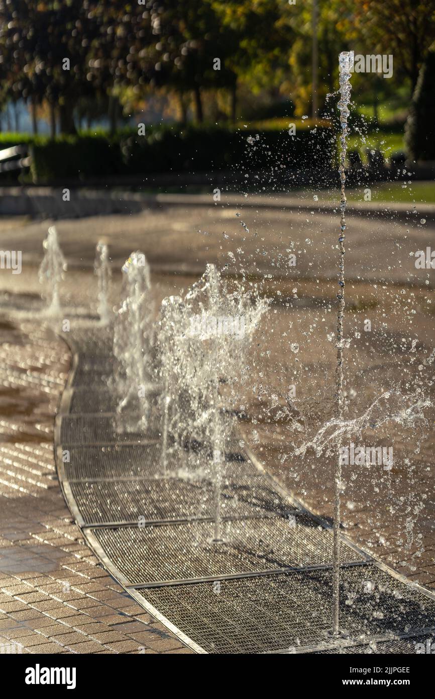 A vertical shot of an upward single spray fountain at a waterpark Stock Photo