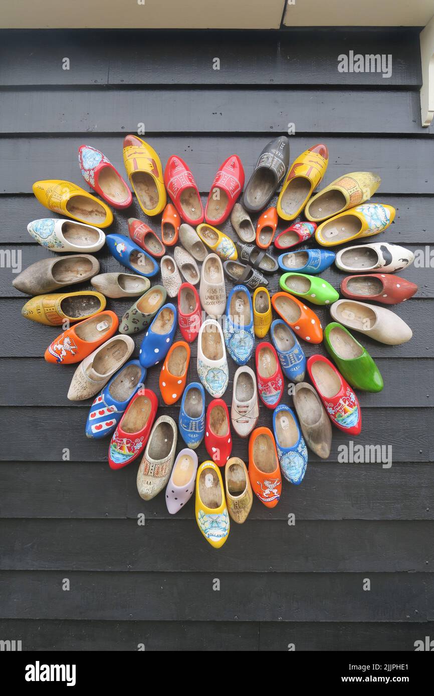 A closeup of clogs in a form of a heart on a wall Stock Photo