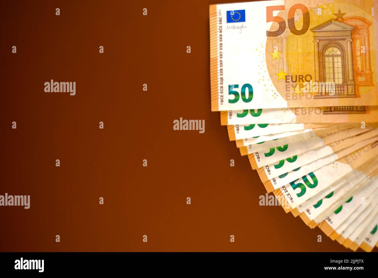 Euro money. Money background.fifty euros banknotes pack set on a brown background.Income and expenses in the EU countries. Stock Photo