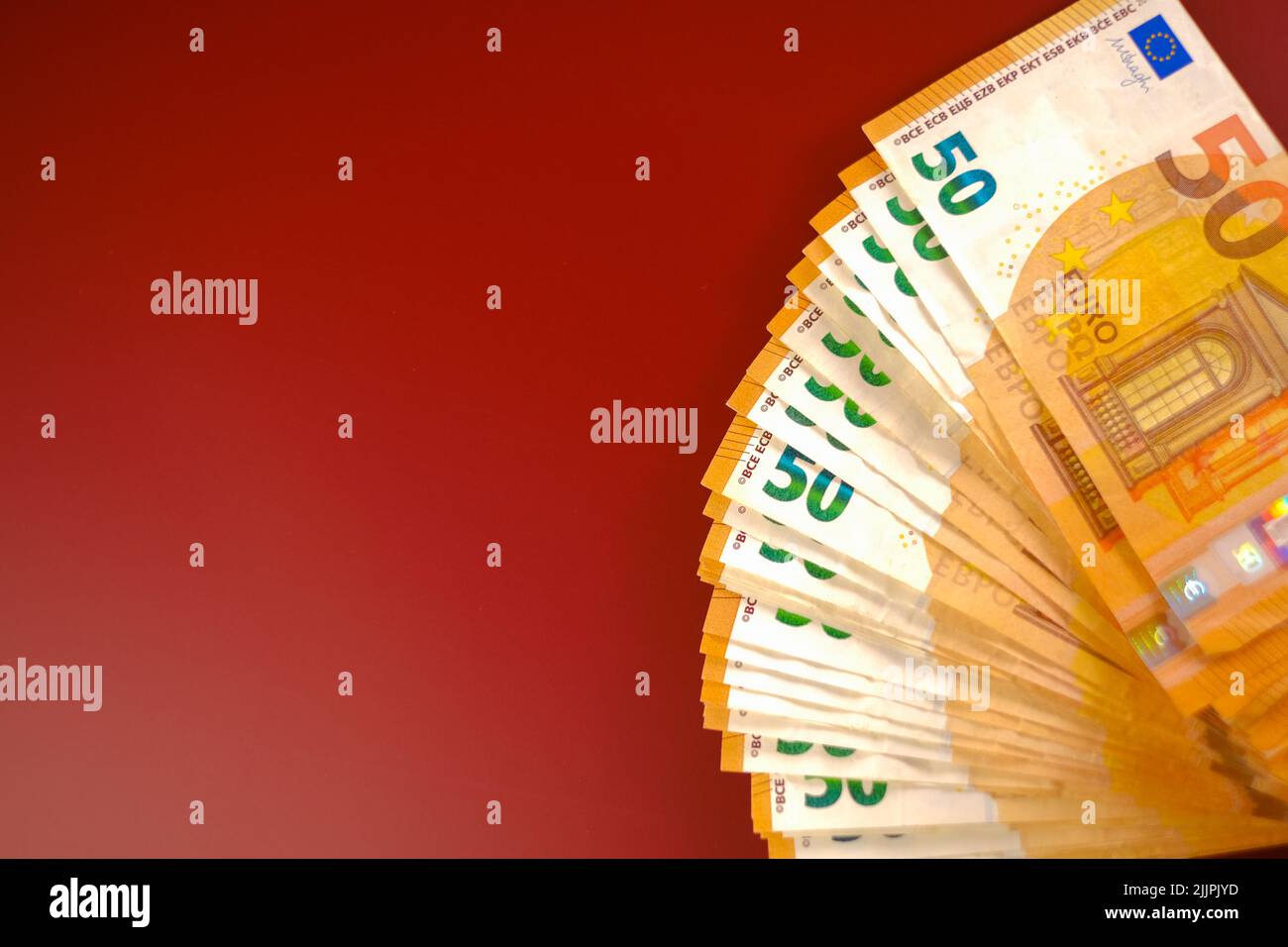 fifty euros banknotes pack set on a burgundy background.Spending and income in European countries.Income and expenses in the EU countries. Stock Photo