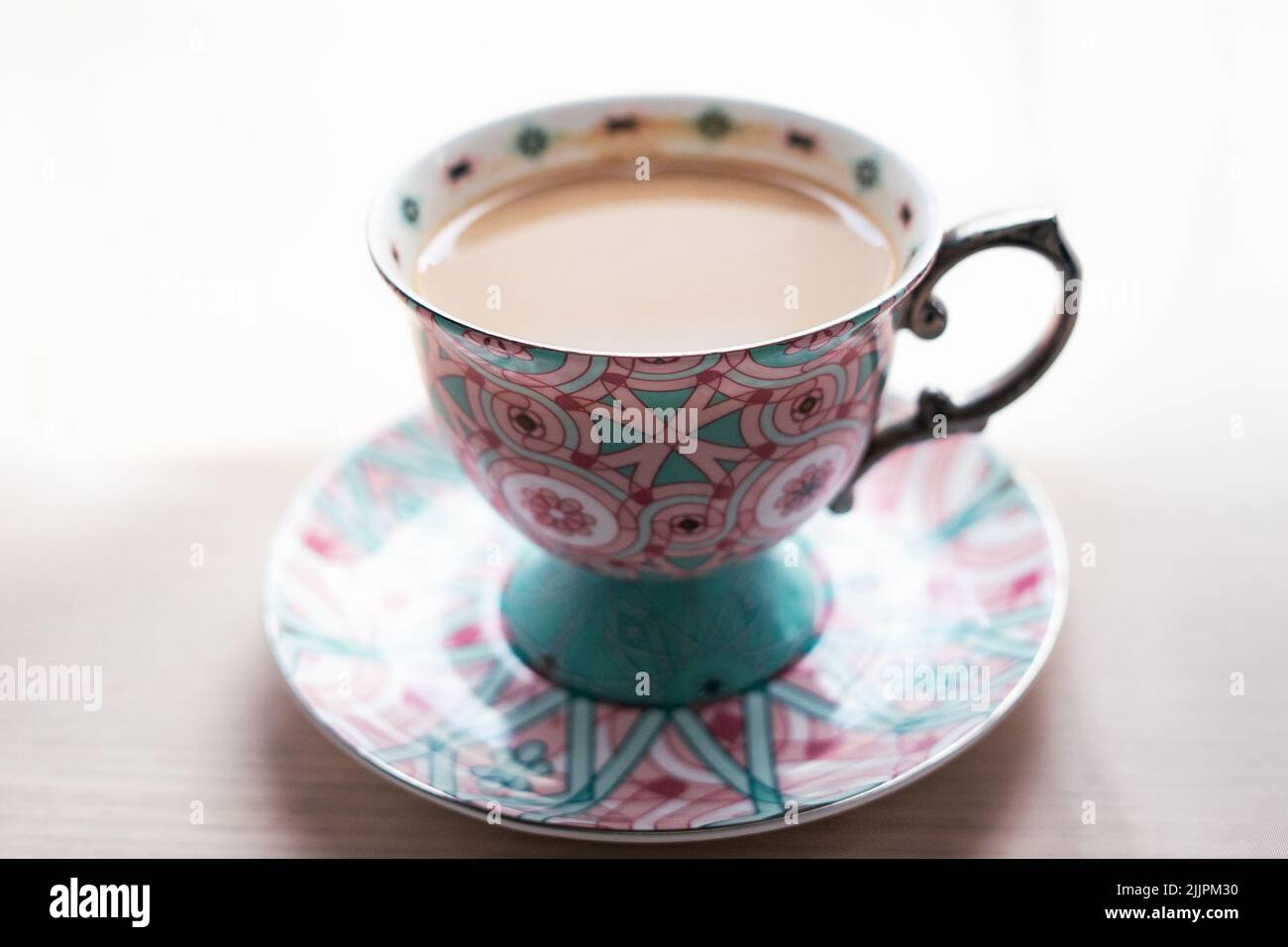 Coffee Cup of tea with milk in a tea cup lying on the table Stock Photo