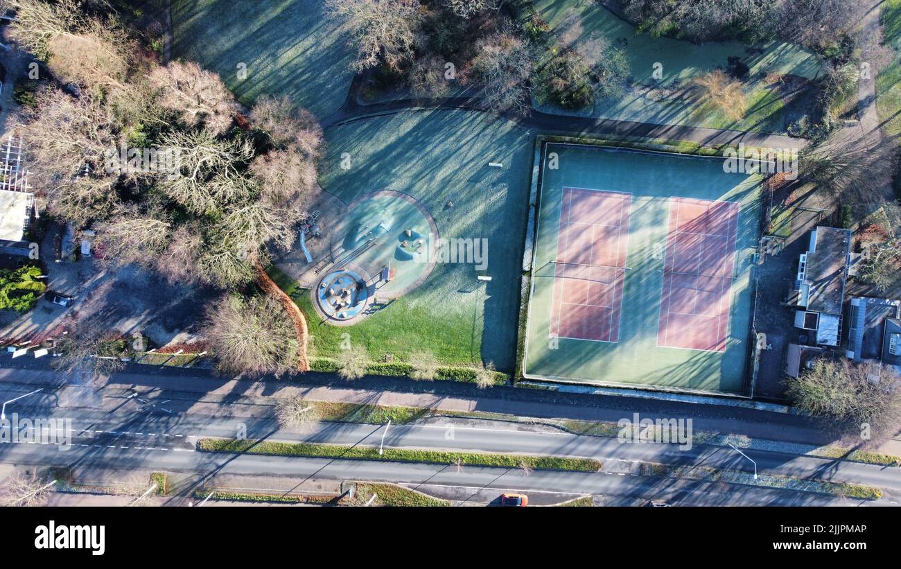 The bird's eye view of the tennis court in the park near the road. Stock Photo