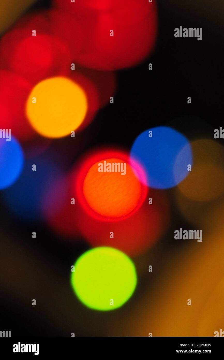 A vertical closeup of a colorful blurry bokeh light background Stock Photo