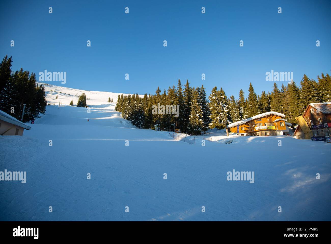 A Fantastic winter landscape with a wooden house in the snowy mountains ...