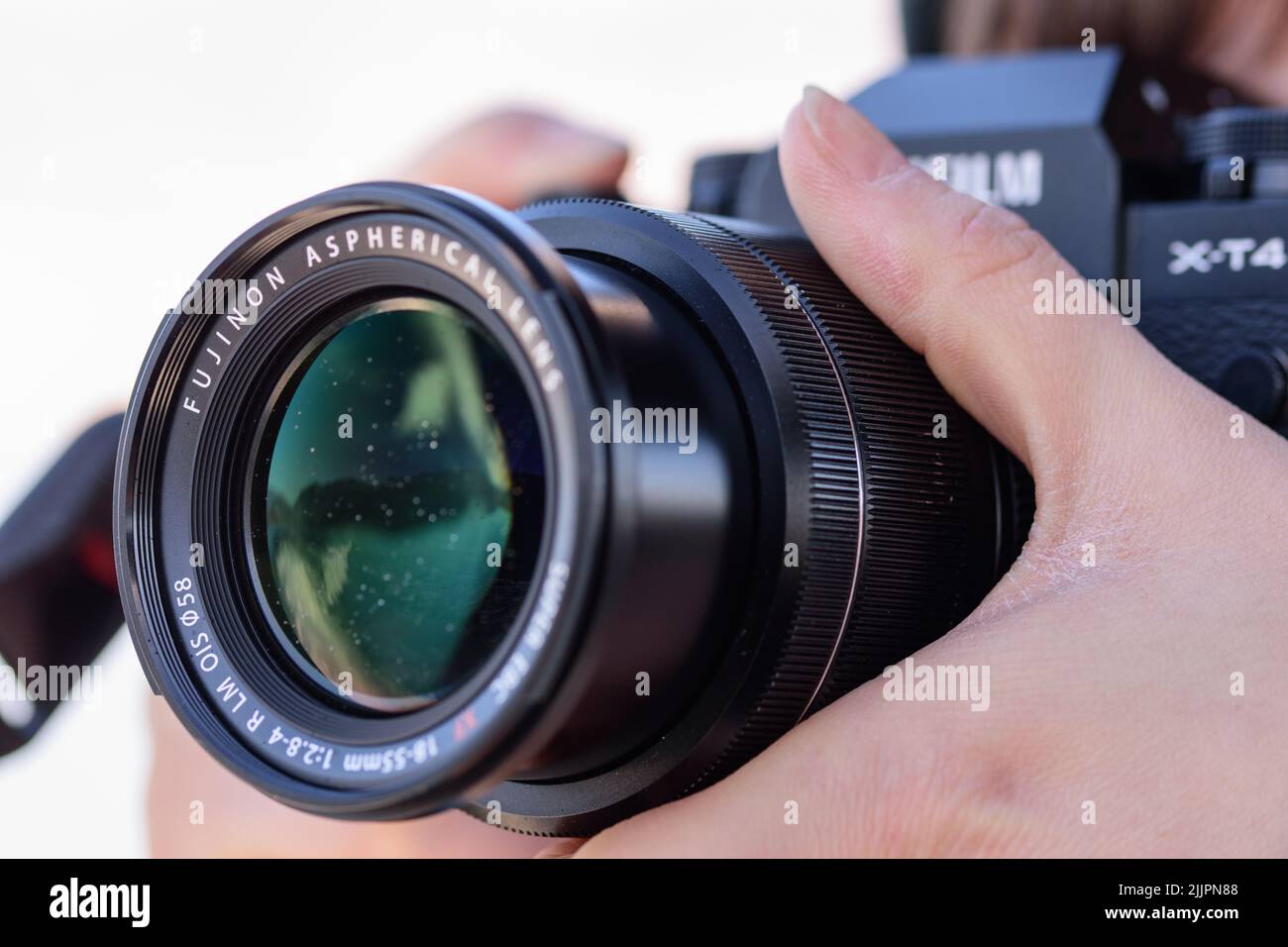 A closeup of a female holding a camera and taking pictures Stock Photo
