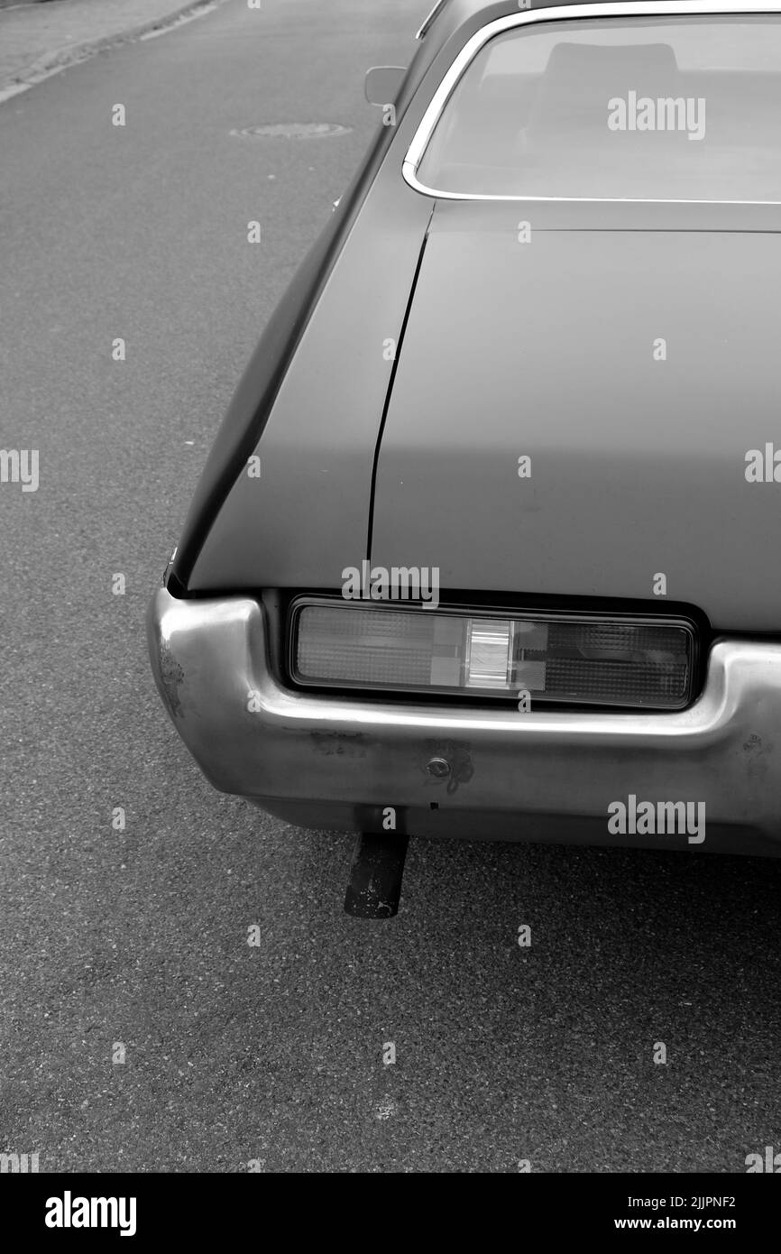 A fog light at the rear of a vintage car on the street Stock Photo