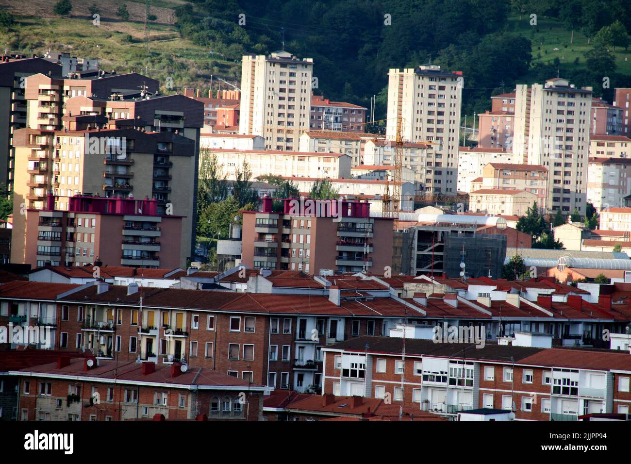 A view of the beautiful city Bilbao with red-roofed buildings, Spain ...