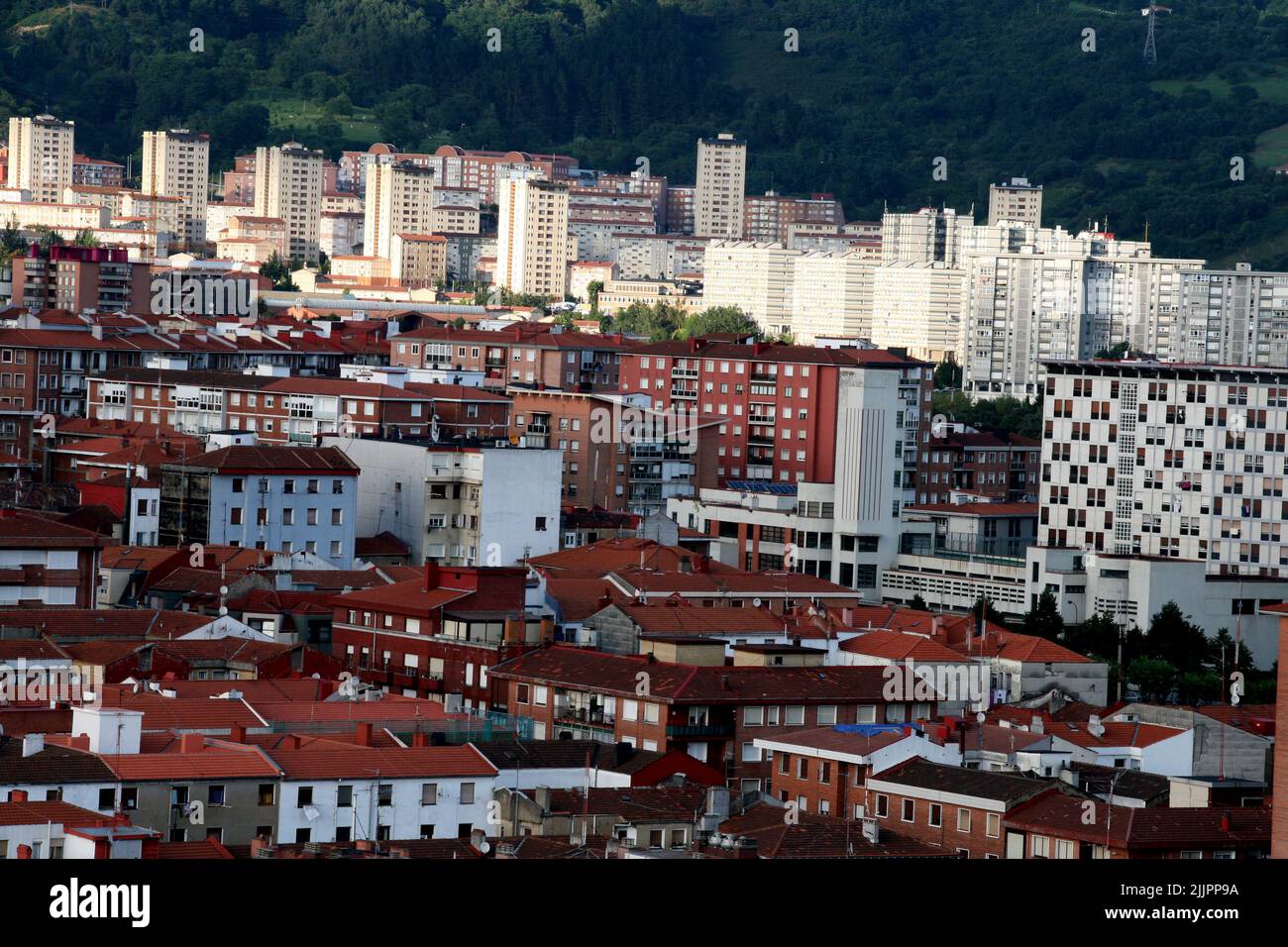 A view of the beautiful city Bilbao with red-roofed buildings, Spain ...