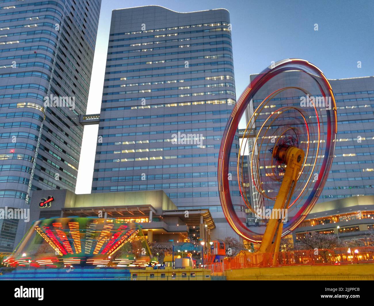A beautiful view of a spinning roller coaster with long exposure in Yokohama Cosmo World, Japan Stock Photo