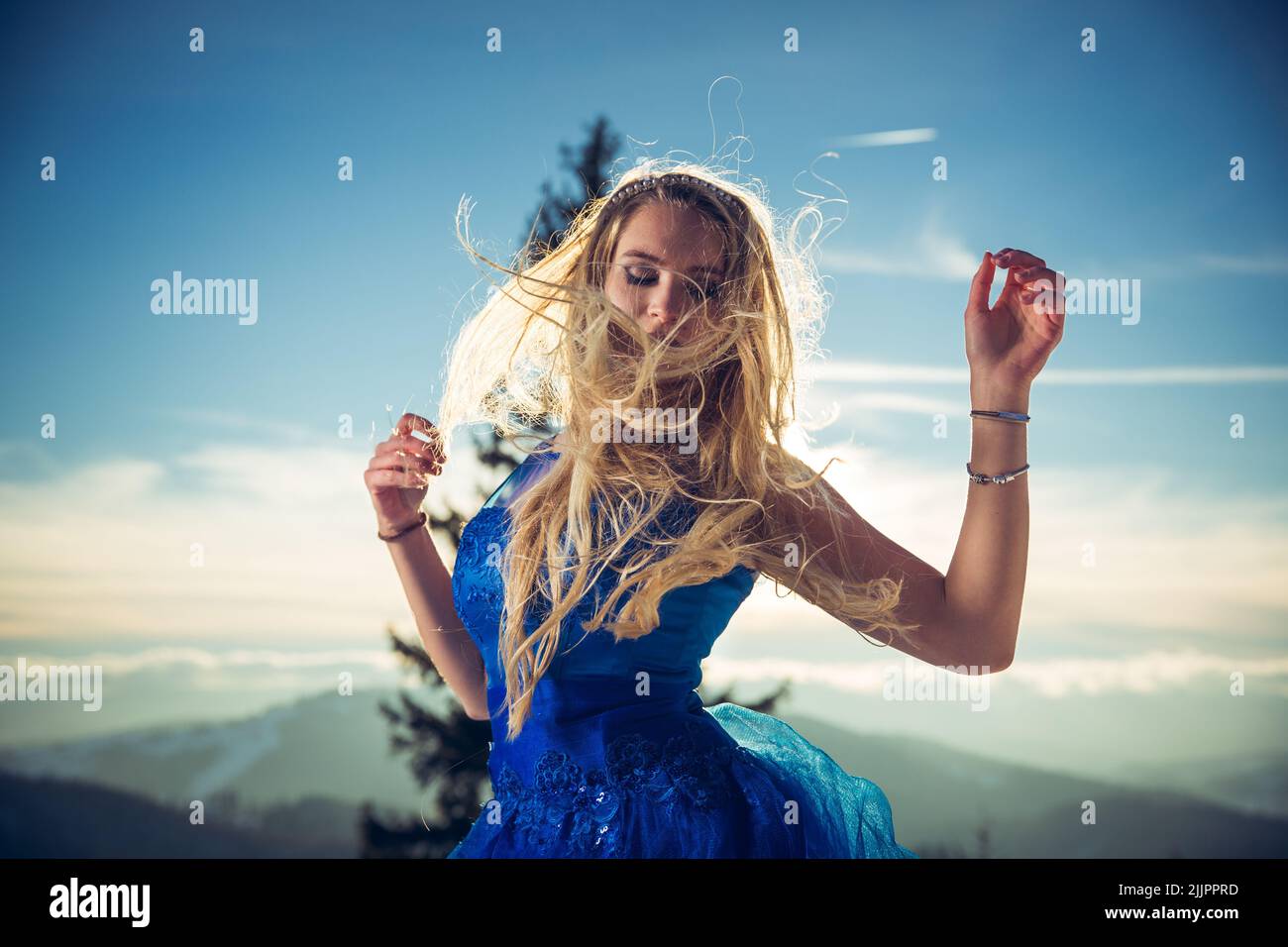 Elegant woman in a blue dress hi-res stock photography and images - Alamy