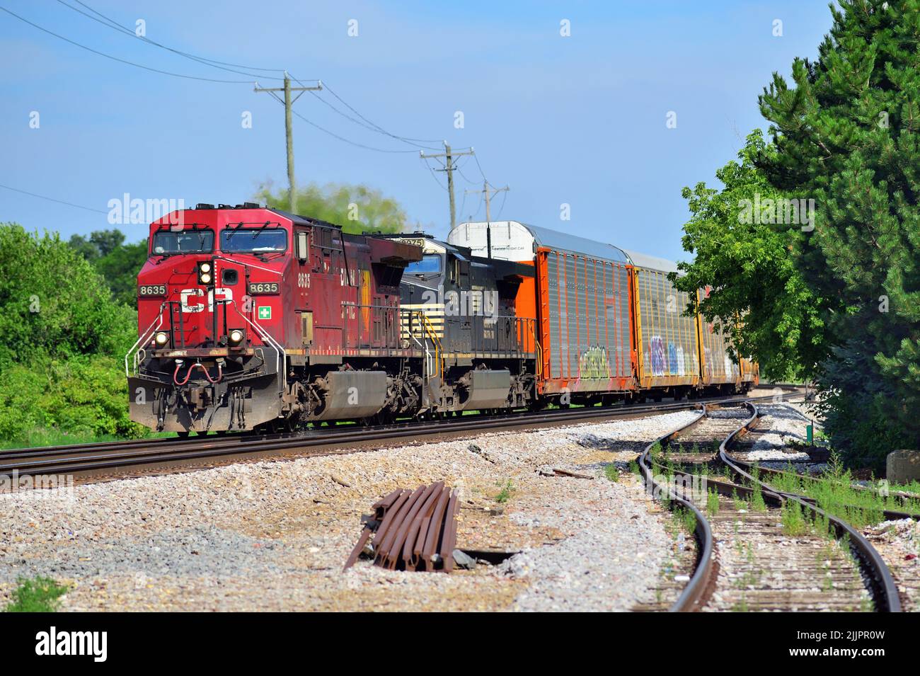 Bartlett, Illinois, USA. A pair of locomotives including an off-road Norfolk Southern unit, power a freight train through northeastern Illinois. Stock Photo