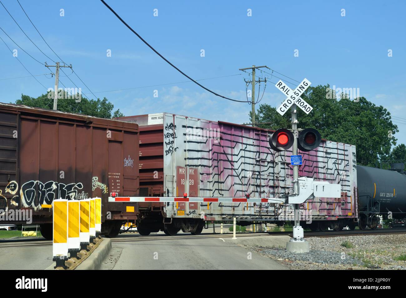 Bartlett, Illinois, USA. Flashing signals at a railroad grade crossing protecting vehicles from rail traffic. Stock Photo