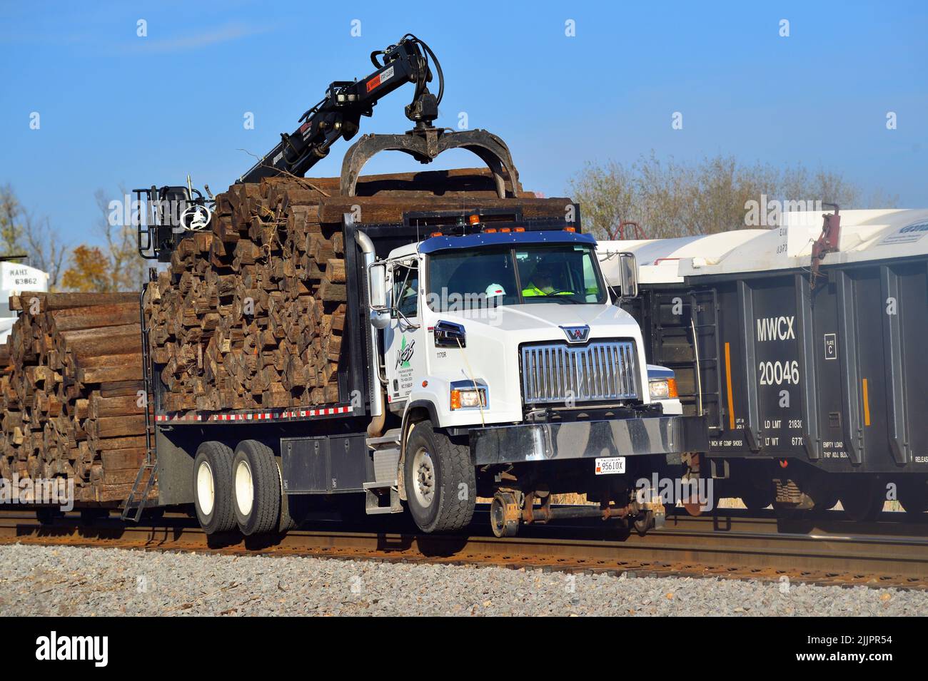 Hoffman Estates, Illinois, USA. A convertible road to rail truck carries and provides pulling power as part of tie replacement work along the route. Stock Photo
