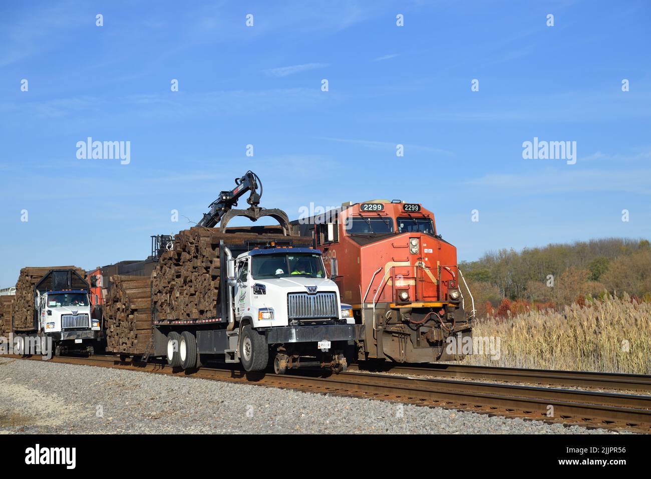 Hoffman Estates, Illinois, USA. Convertible road to rail trucks carry and provide pulling power as part of a tie replacement effort along the tracks. Stock Photo