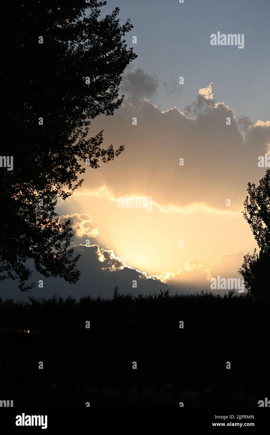 A silhouette of farm and trees with sunset view Stock Photo - Alamy