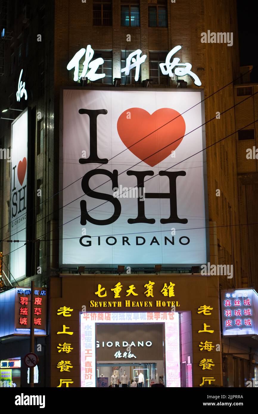 A closeup of I love Shanghai sign with neon lights in front of a building Stock Photo