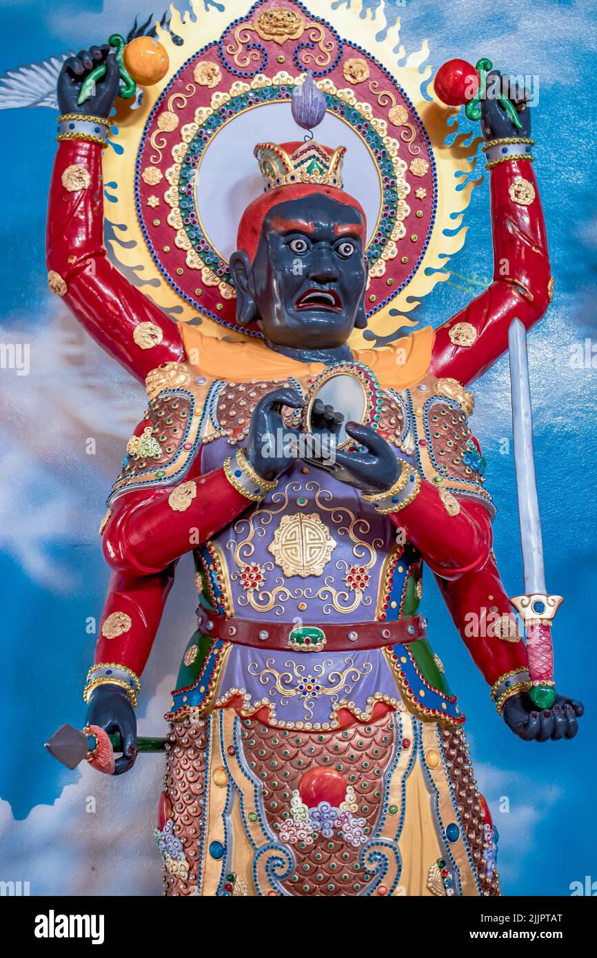 A portrait of a Chinese god statue in a temple in Chonburi, Thailand