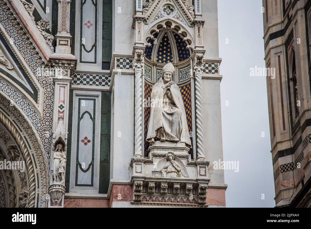 A shot of religious sculpture and artistic design on a wall of a church in Florence, Tuscany, Italy Stock Photo