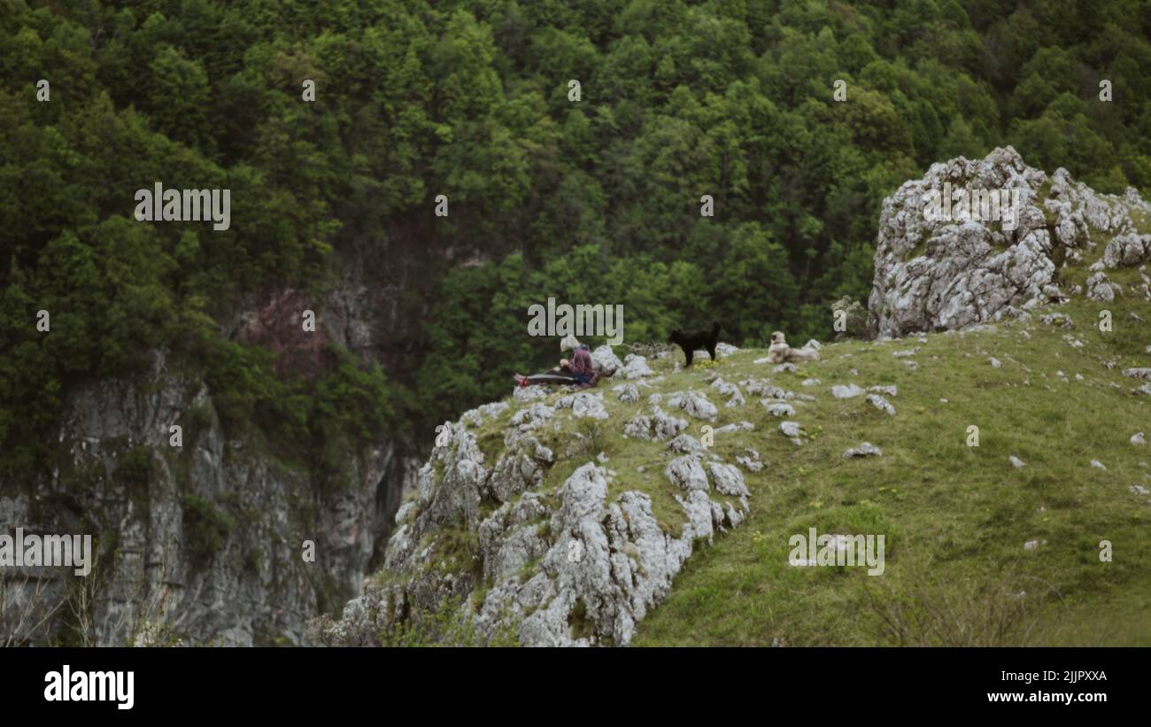 Girl sitting on edge cliff hi-res stock photography and images - Alamy