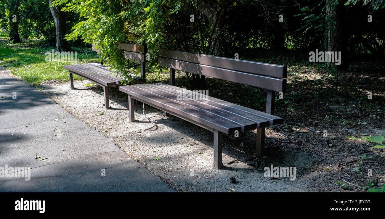 A photo of two empty benches in a park Stock Photo - Alamy
