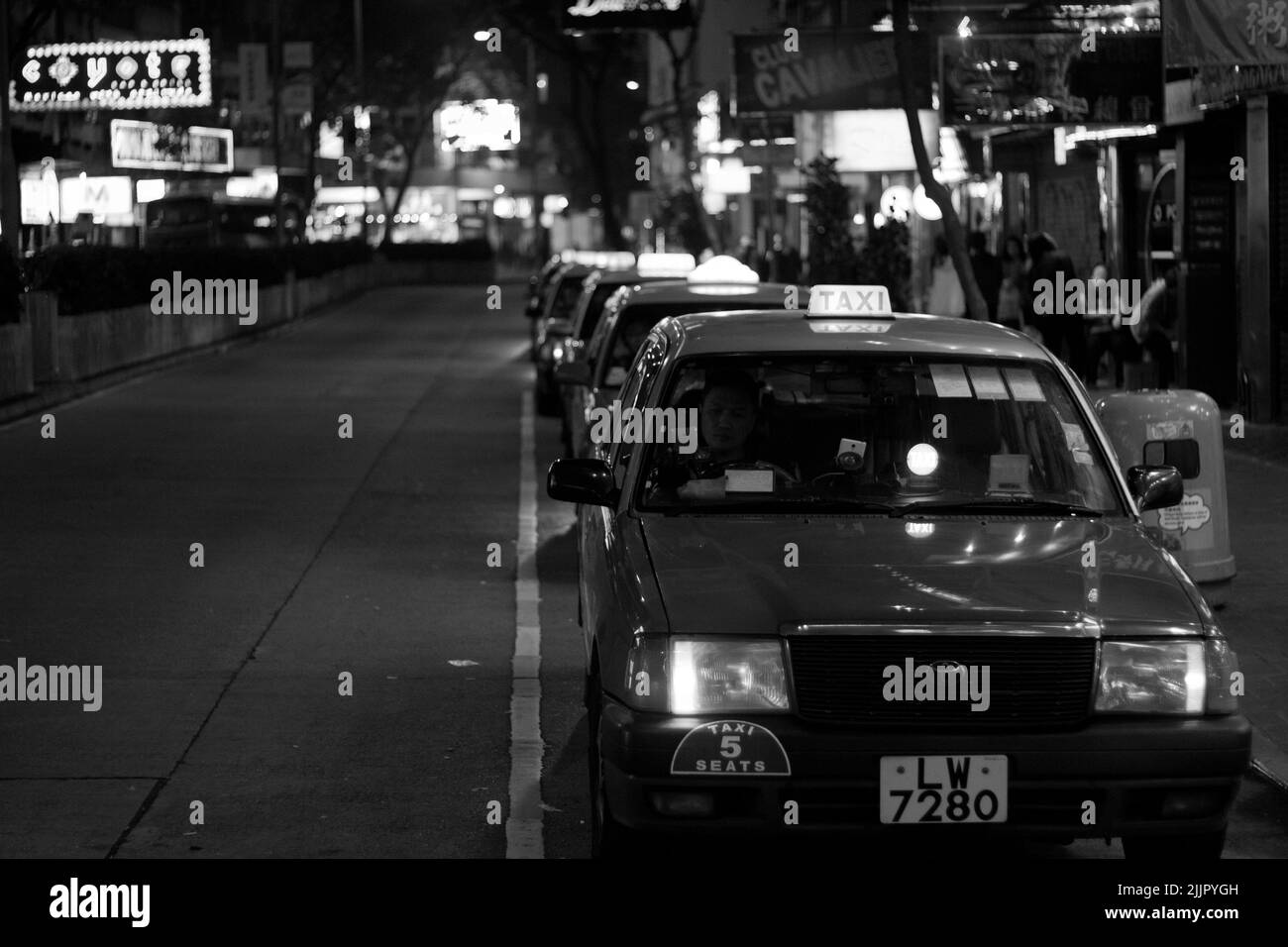 A beautiful shot of a taxi rank in Hong Kong in grayscale Stock Photo
