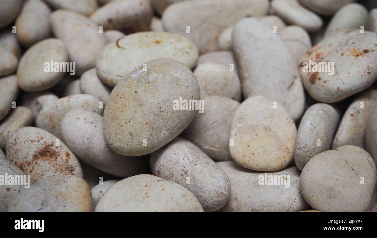 A macro view of small grey rocks with texture and patterns Stock Photo