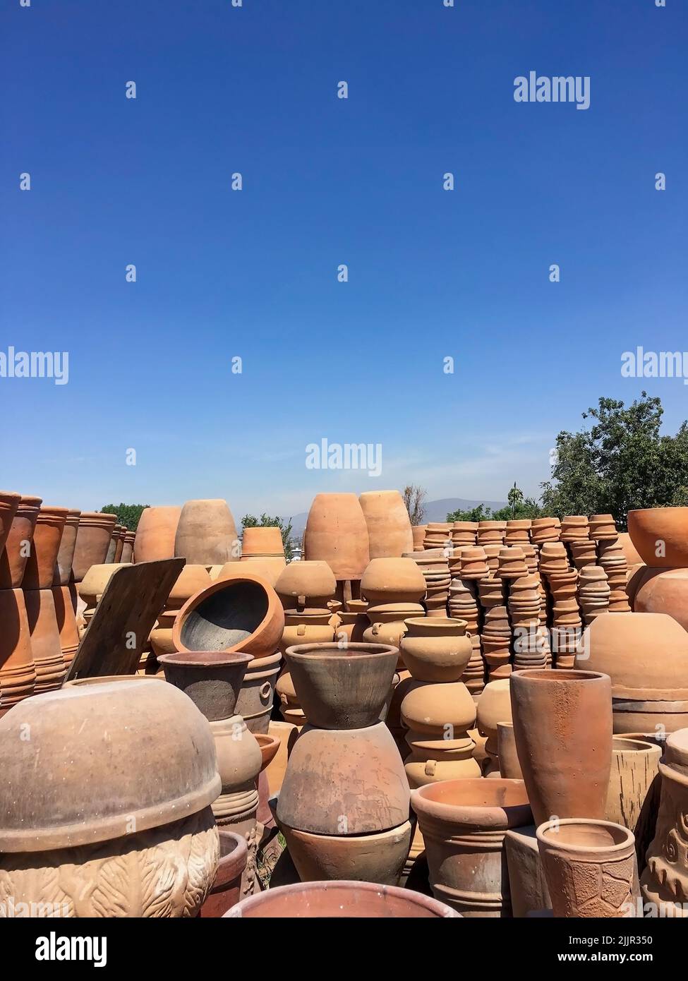 Stacks of various terracotta pots for plants for sale at a garden store