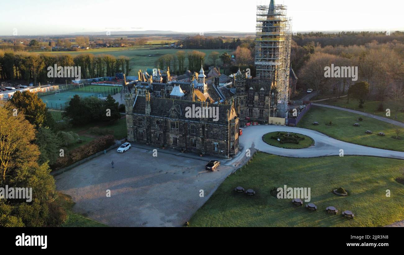 An aerial shot of the Scarisbrick Hall surrounded by green fields in