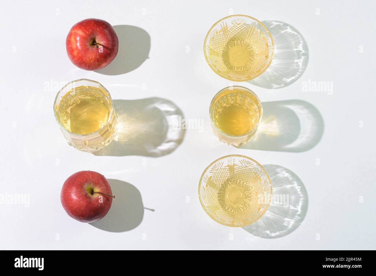 Apple cider vinegar and apples arranged on a table Stock Photo