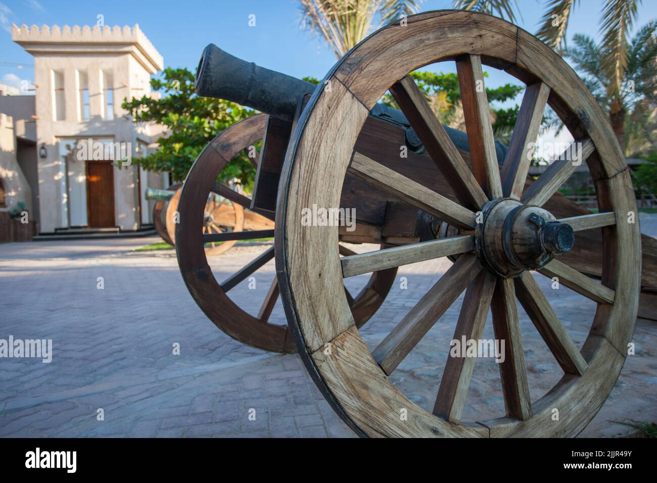 Persian cannon on wooden wheels in the courtyard of a fort in Dubai, United Arab Emirates Stock Photo