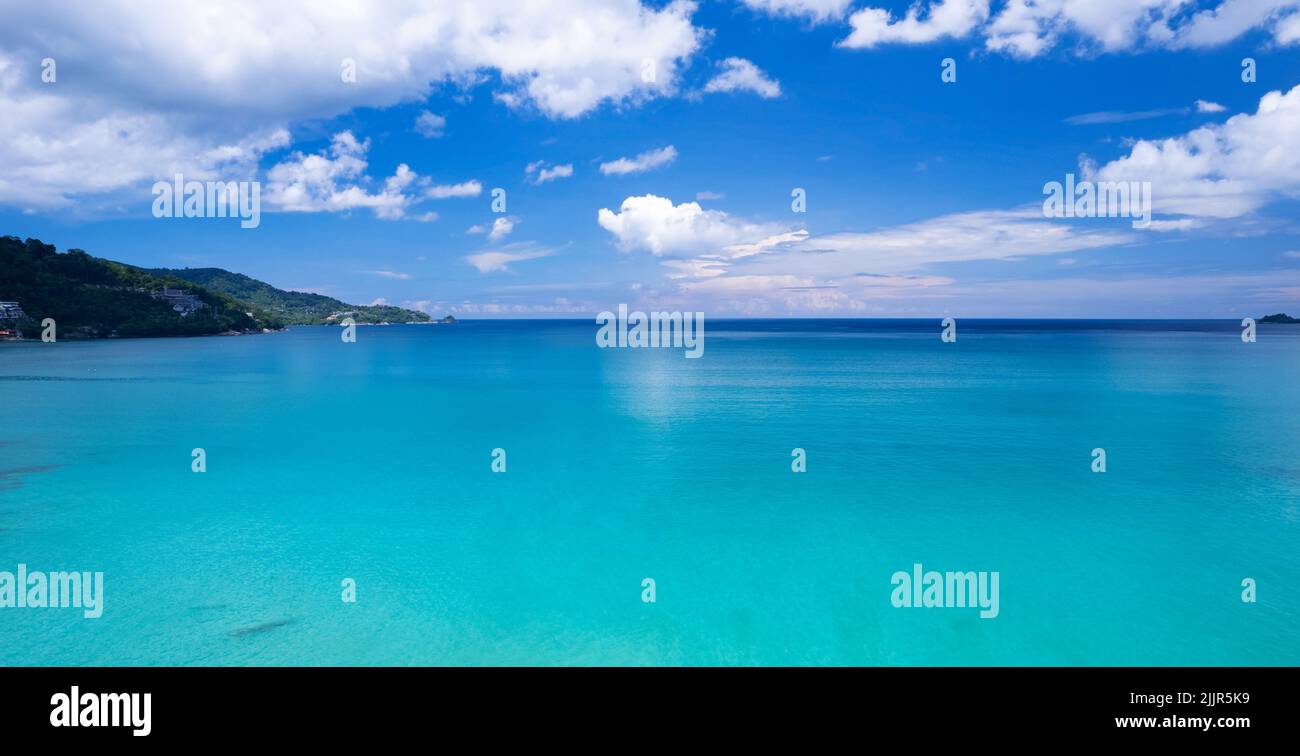 Aerial view of a blue sea surface water texture background and sun ...