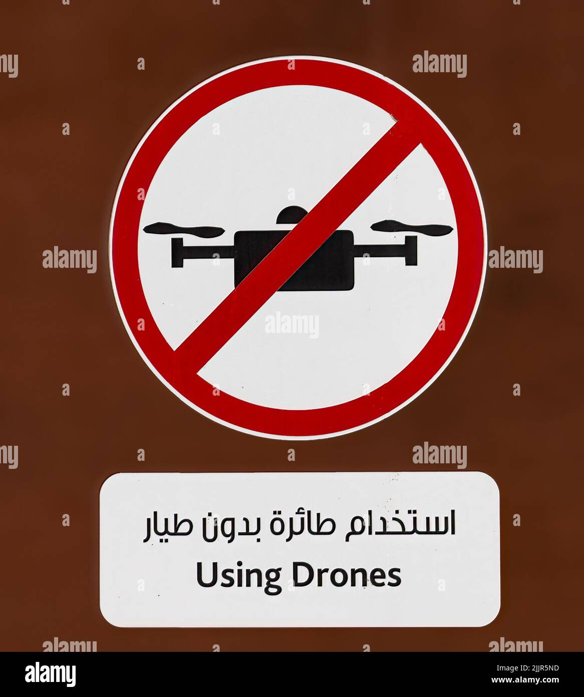 A vector illustration of a sign with the symbol ,, Unmanned Aerial Vehicles are Prohibited ,,on a red background Stock Photo