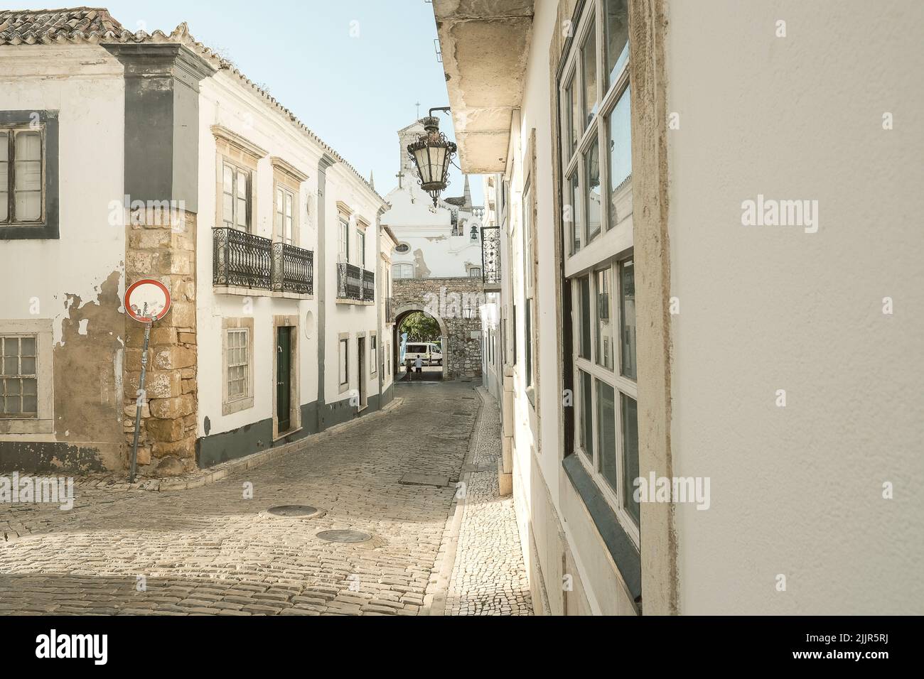 A vertical shot of a old cobblestone street with old buildings in Portugal Stock Photo