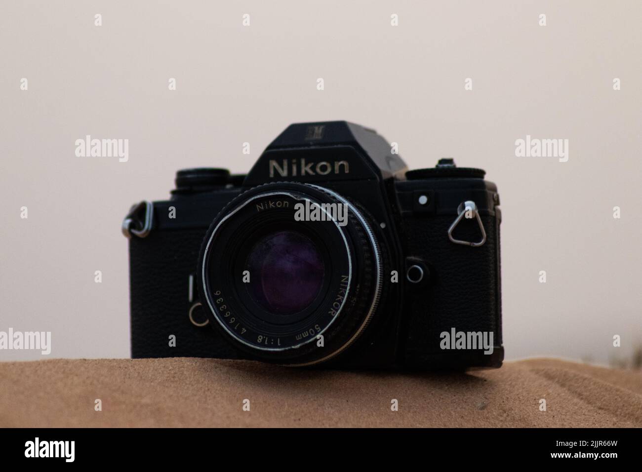 A professional Nikon film camera on a blurred background in the desert