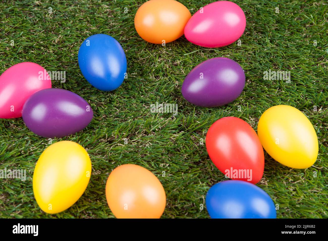 The artificial colored eggs on the grass - Easter concept Stock Photo