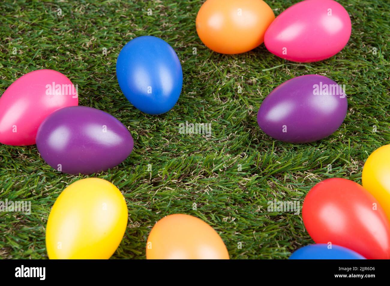 The artificial colored eggs on the grass - Easter concept Stock Photo