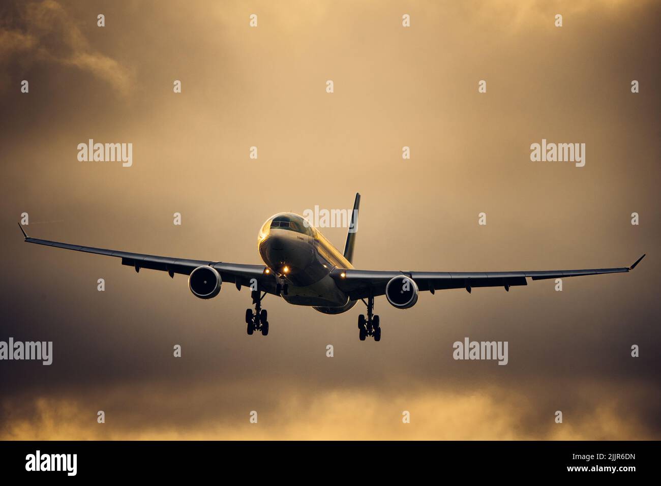 A shot of an Aer Lingus Airbus airliner with a dark cloudy background Stock Photo